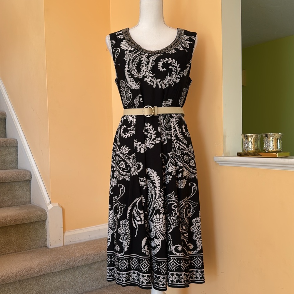 Sleeveless slip on easy care embellished at the neck gentle flare at hip dress
